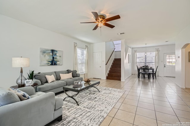 living room featuring light tile patterned floors and ceiling fan