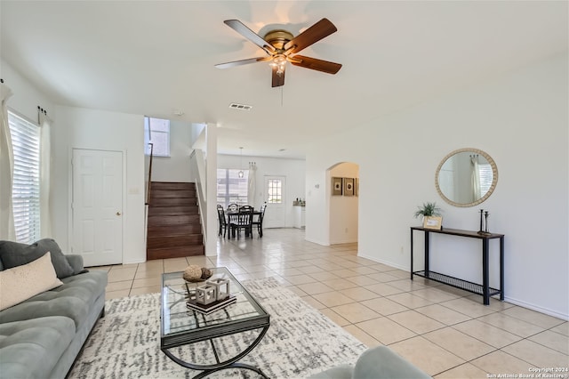 living room with ceiling fan, plenty of natural light, and light tile patterned floors