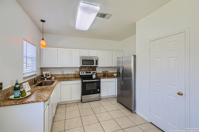 kitchen with pendant lighting, sink, light tile patterned floors, appliances with stainless steel finishes, and white cabinetry