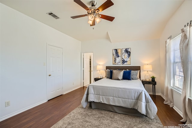 bedroom with ceiling fan, dark hardwood / wood-style floors, and multiple windows