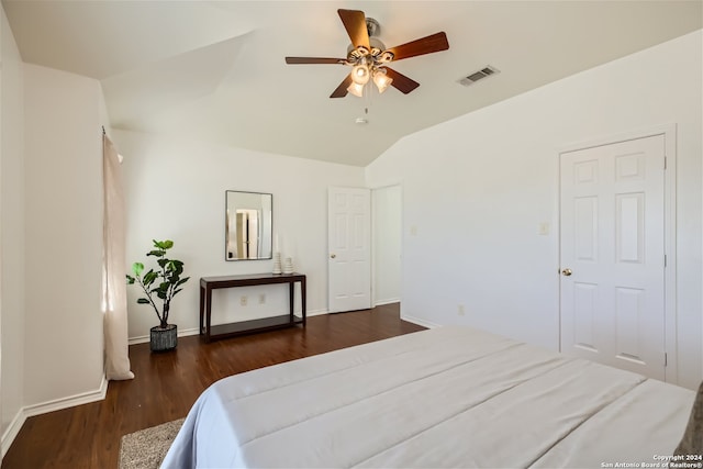 bedroom featuring ceiling fan, dark hardwood / wood-style floors, and lofted ceiling