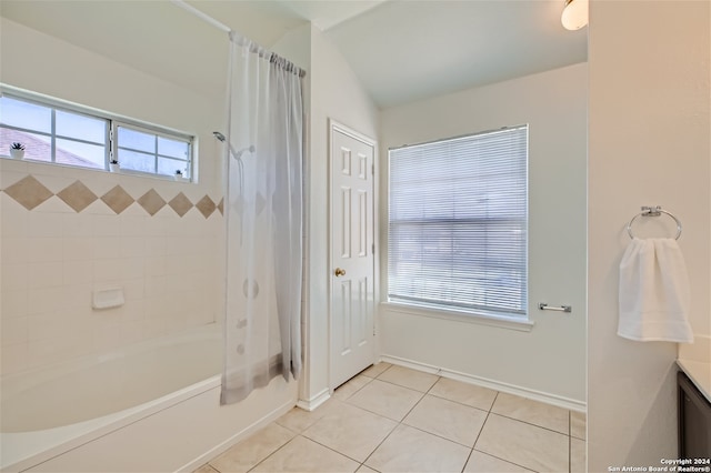 bathroom featuring vaulted ceiling, tile patterned flooring, and shower / tub combo