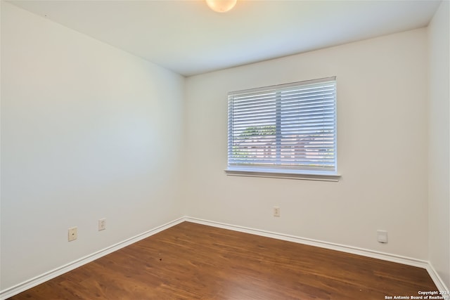 empty room featuring dark hardwood / wood-style flooring