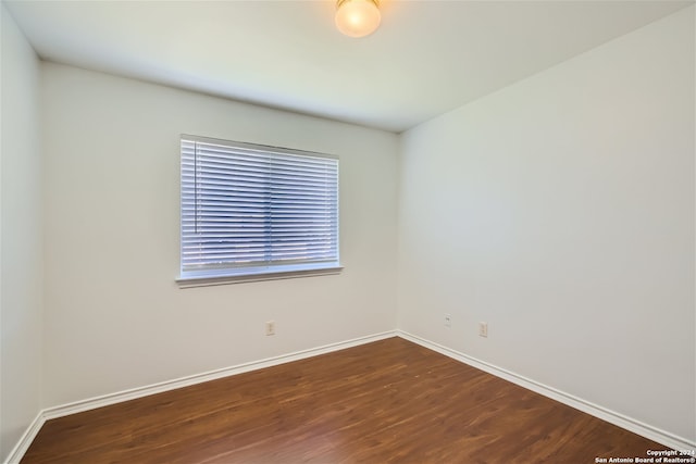 spare room featuring dark hardwood / wood-style floors