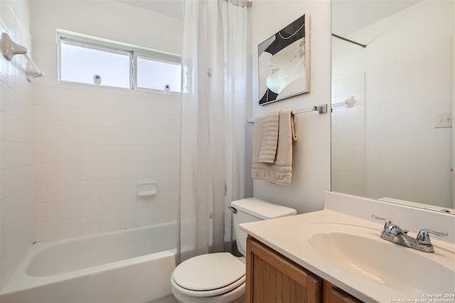 full bathroom featuring vanity, shower / tub combo, and toilet