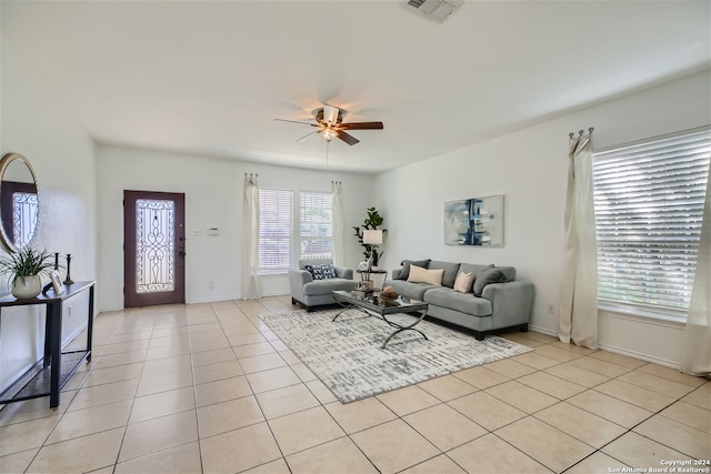 living room with ceiling fan and light tile patterned floors