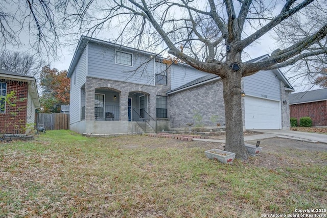 view of front of home with a porch, a garage, and a front yard