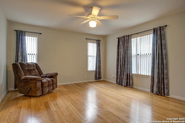 sitting room featuring light wood-type flooring and ceiling fan