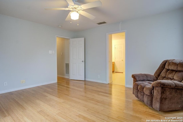 living area with light wood-type flooring and ceiling fan