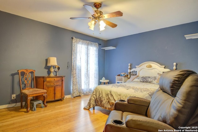 bedroom with ceiling fan and light hardwood / wood-style floors