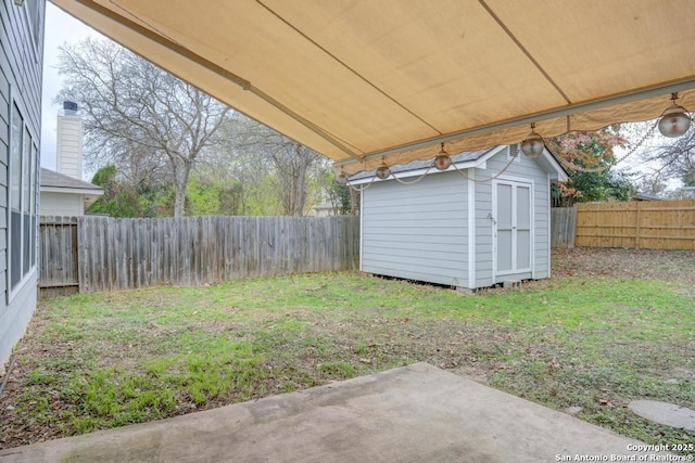 view of yard with a patio and a storage unit