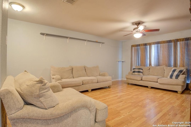 living room featuring hardwood / wood-style flooring and ceiling fan