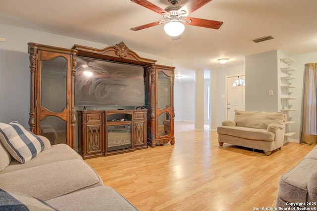 living room featuring light hardwood / wood-style floors and ceiling fan