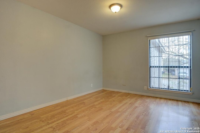 empty room with light hardwood / wood-style flooring