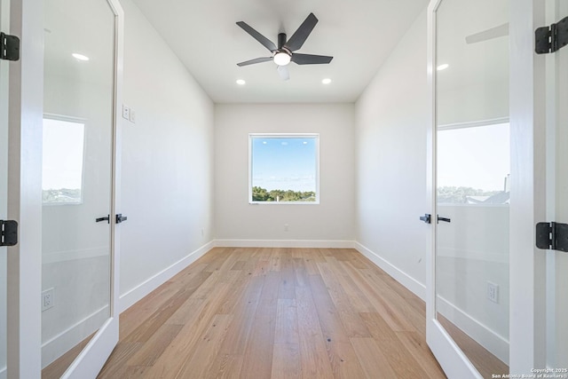 spare room featuring ceiling fan and light wood-type flooring