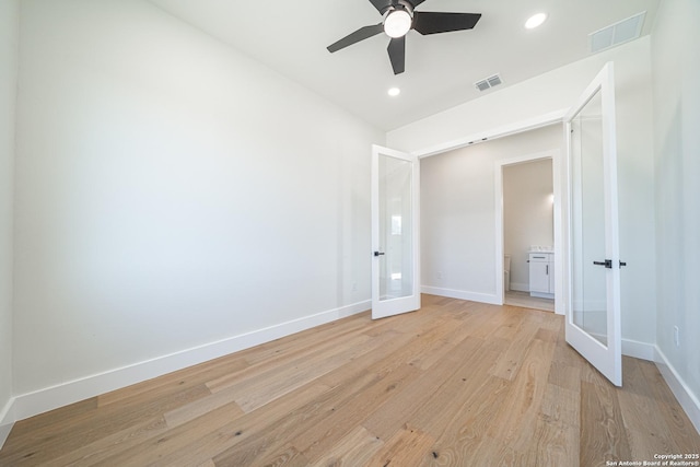 spare room featuring ceiling fan, light wood-type flooring, and french doors