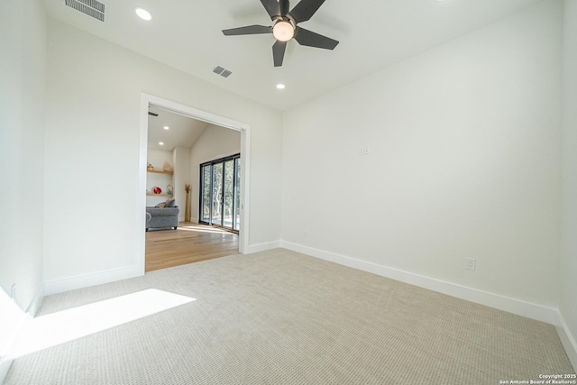 carpeted spare room with vaulted ceiling and ceiling fan