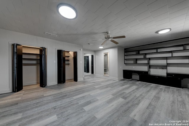 unfurnished living room featuring ceiling fan and light wood-type flooring