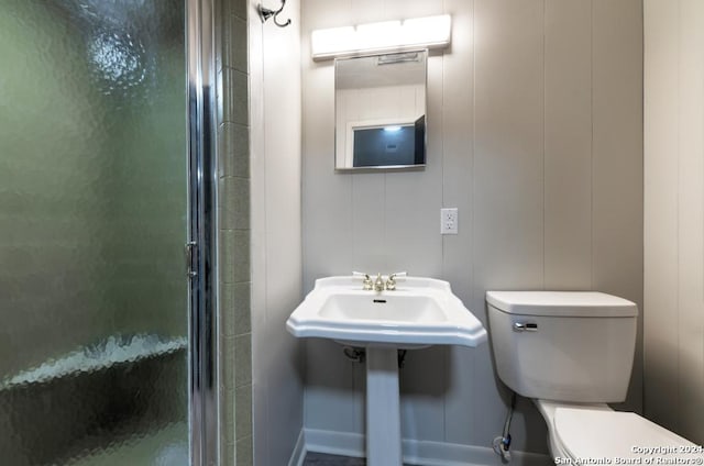 bathroom with toilet and walk in shower