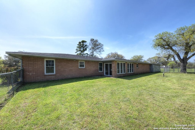 rear view of property with a lawn