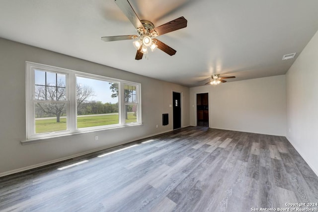 unfurnished living room with light hardwood / wood-style floors and ceiling fan