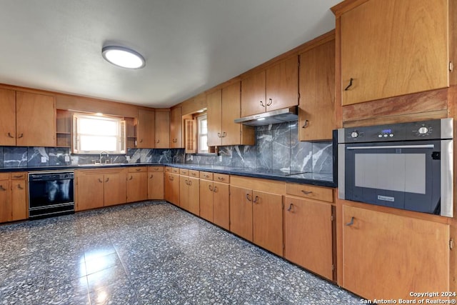 kitchen featuring black appliances, sink, and tasteful backsplash