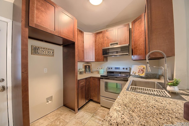 kitchen with light stone countertops, sink, and appliances with stainless steel finishes