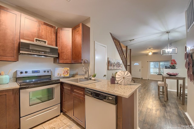 kitchen featuring stainless steel range with electric stovetop, white dishwasher, sink, range hood, and a notable chandelier