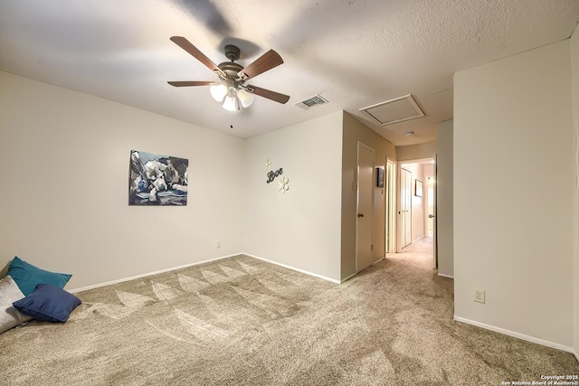 carpeted spare room with ceiling fan and a textured ceiling