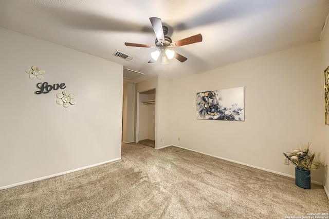 carpeted empty room featuring ceiling fan