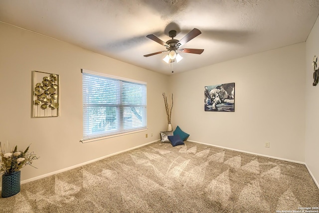 spare room featuring carpet flooring and ceiling fan