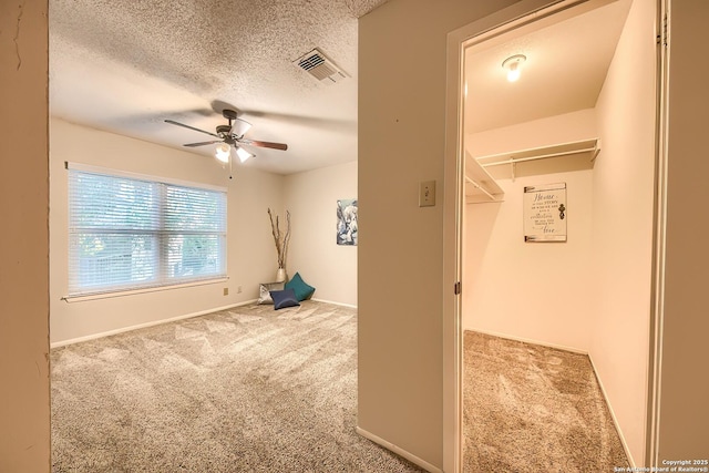 interior space featuring a textured ceiling and ceiling fan