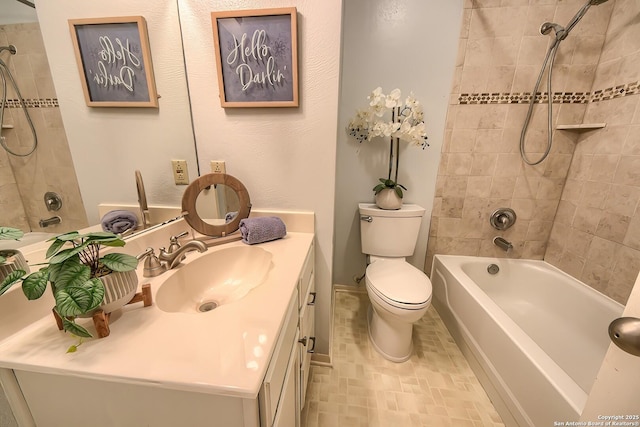 full bathroom featuring vanity, toilet, and tiled shower / bath combo