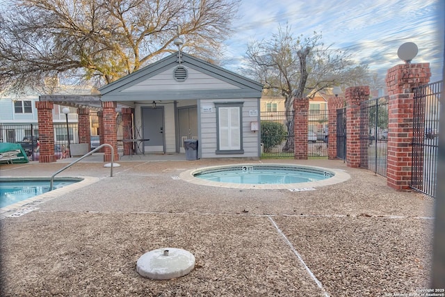 view of swimming pool featuring a jacuzzi and a patio area