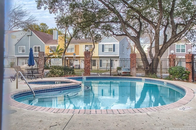 view of swimming pool featuring a community hot tub