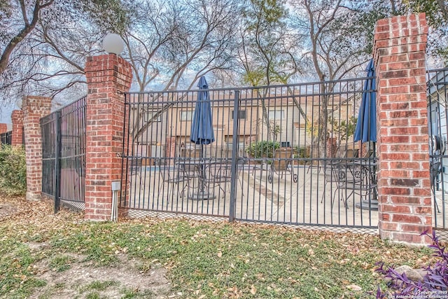 view of gate featuring a patio area