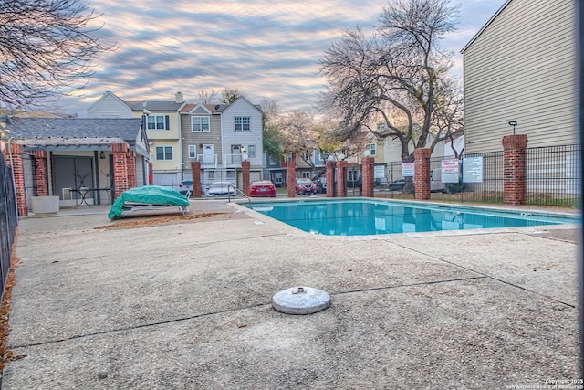 pool at dusk with a patio