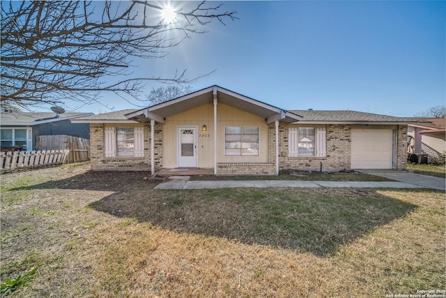 ranch-style house with a front yard, a garage, and central AC unit