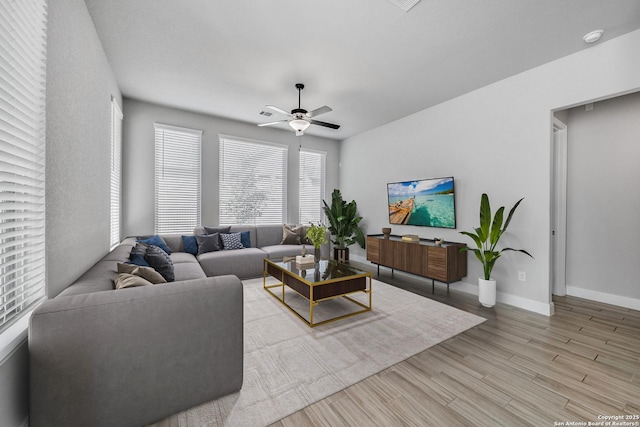 living room featuring light wood-type flooring and ceiling fan