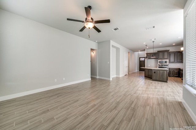 unfurnished living room featuring ceiling fan