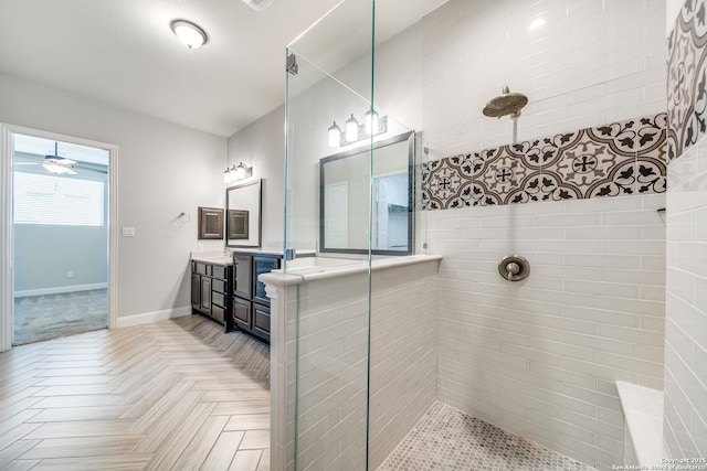 bathroom with parquet flooring, a tile shower, and vanity