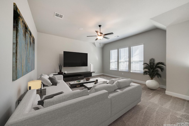 living room featuring carpet, ceiling fan, and lofted ceiling