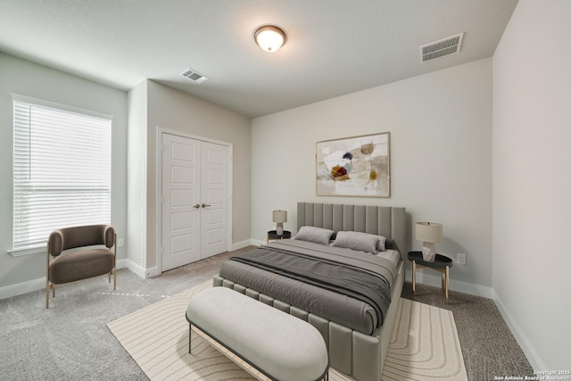 bedroom with a closet and light colored carpet