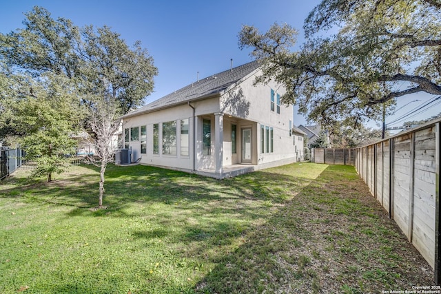 back of property with a lawn and cooling unit