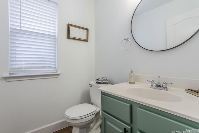 bathroom featuring vanity and toilet