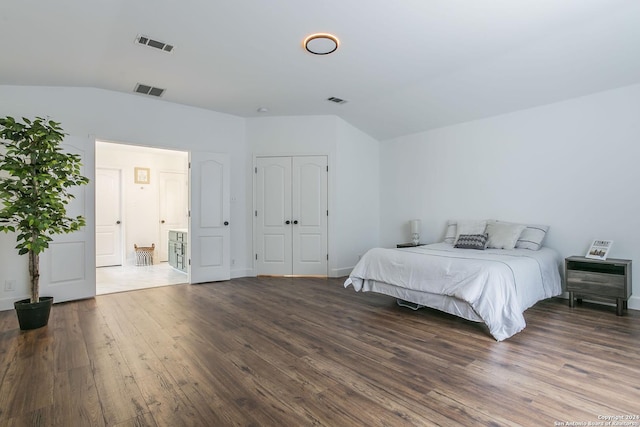 bedroom with dark hardwood / wood-style flooring and lofted ceiling