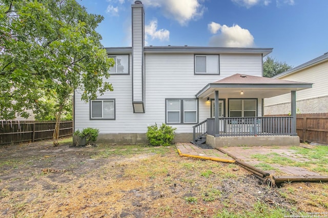 back of property featuring a porch