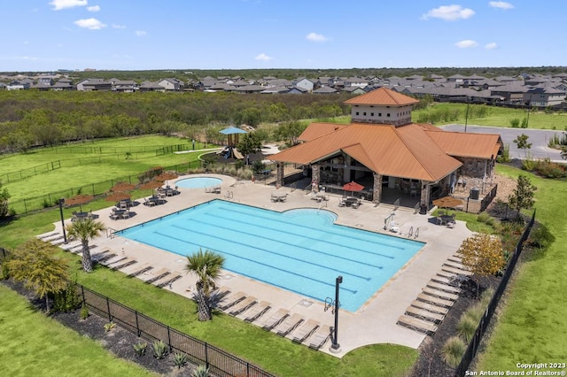 view of swimming pool featuring a yard and a patio