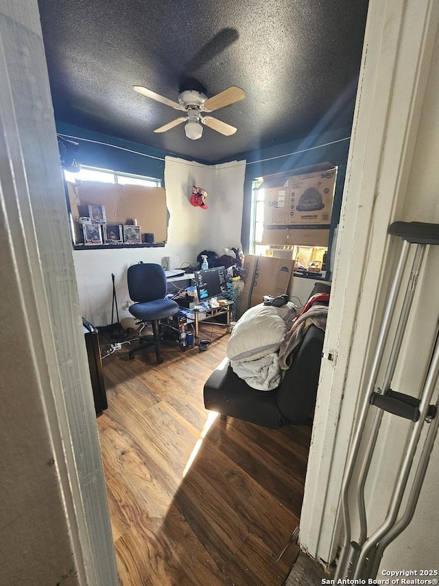 interior space featuring hardwood / wood-style floors, a textured ceiling, a wealth of natural light, and ceiling fan