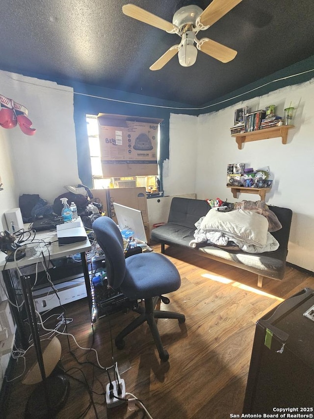 office space featuring ceiling fan, a textured ceiling, and hardwood / wood-style flooring